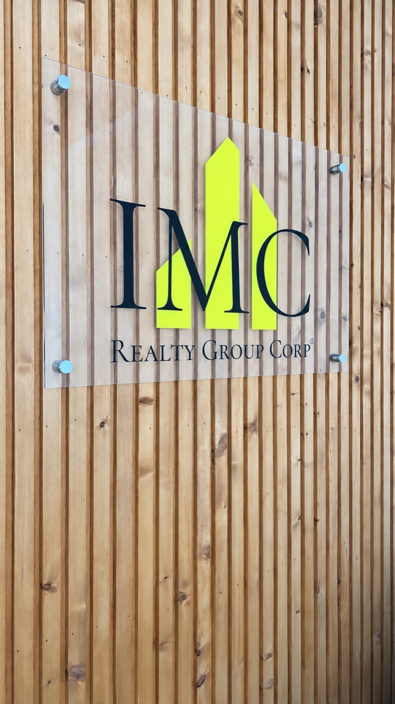 Custom dimensional IMC logo installed on a wood slat wall